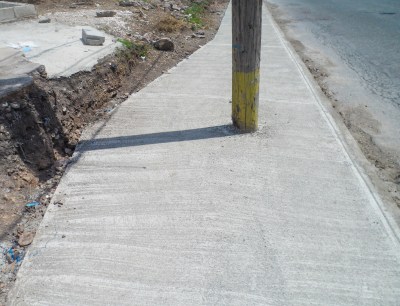 There were electricity poles in the middle of the sidewalk which made it impassable for the disabled. It would have been quite costly to remove all the poles. This is the method they used to solve the problem.