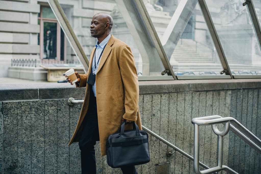 contemplative black businessman leaving metro station